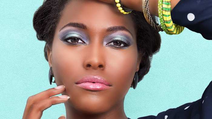 Woman with blue eyeshadow and jewelry.